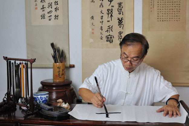 man doing calligraphy