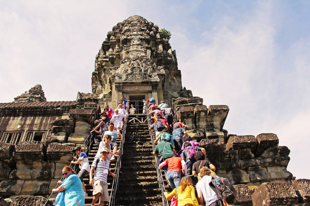visitors climbing temple
