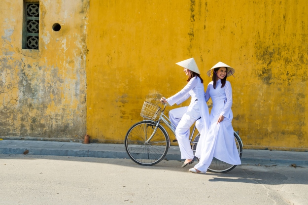 girls in non las riding bike in Vietnam