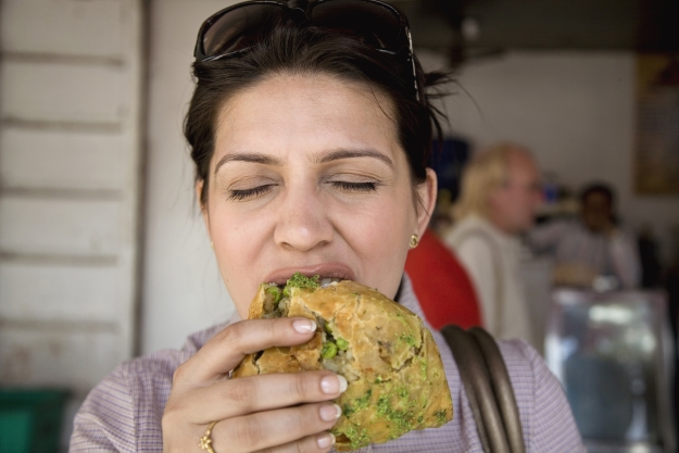 Woman eating vegetarian street food in India