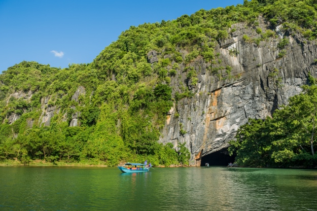 A boat entering a cave, Phong Nha National Park in Vietnam.