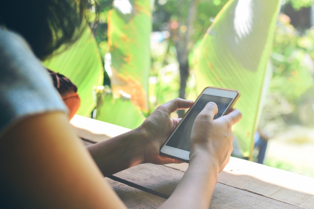 Woman looking at her phone on holiday