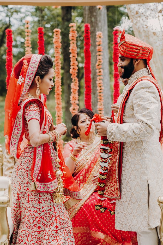 Bride and groom in elaborate traditional wedding outfits