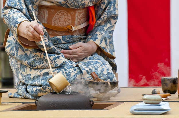 Woman performing Japanese tea ceremony