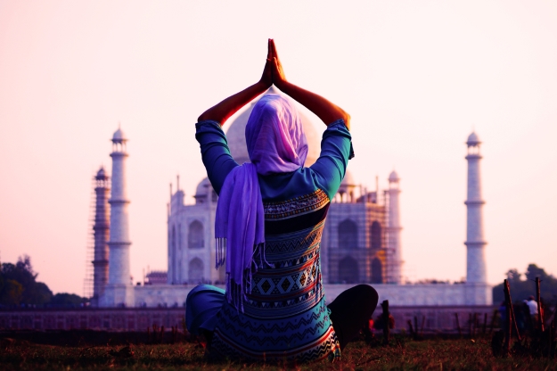 Woman practicing yoga at Taj Mahal