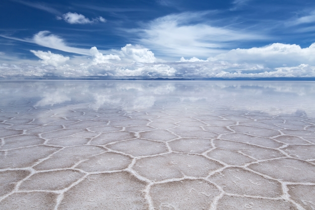 Salt flats reflecting the blue sky