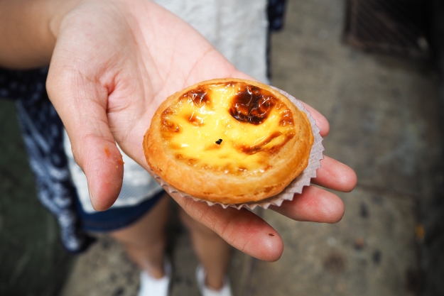 Hand holding an egg tart