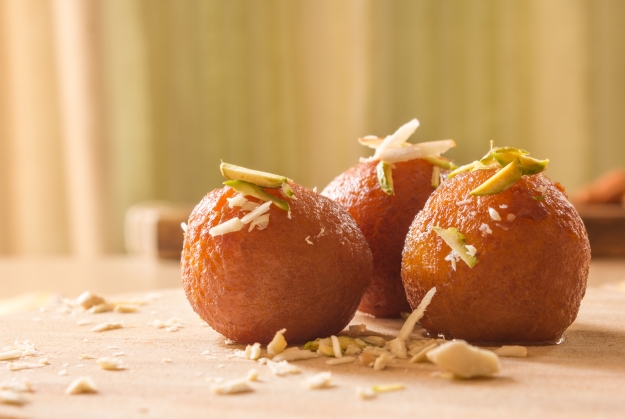 Gulab jamun decorated with nuts