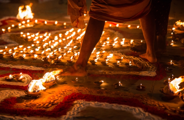 Man walking barefoot amongst candles