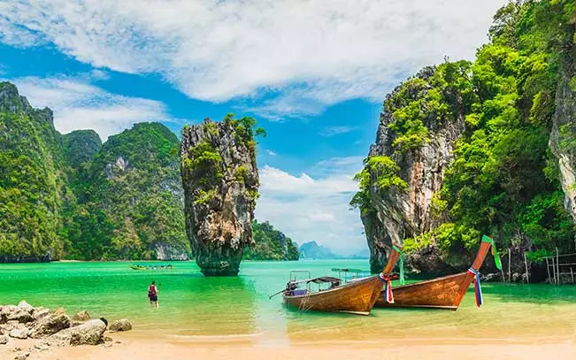 Take a longtail boat through the otherworldly Phang Nga Bay, where immense limestone towers erupt dramatically from the emerald waters. A quarter of the size of Halong Bay, but no